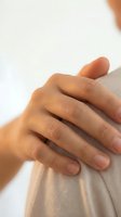 Close-up of a hand resting on a shoulder, conveying support, empathy, and comfort in healthcare, wellness, and mental health concepts.