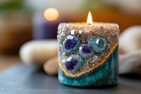 Glowing crystal candle holder with amethyst and agate geodes embedded in turquoise resin, lit flame creating magical ambiance on dark surface.