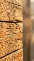 Close-up of weathered wooden planks showing natural grain texture and aging patterns for rustic construction and carpentry projects.