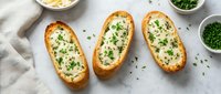 Golden baked potato boats filled with creamy mashed potatoes and fresh green herbs, served on white marble surface for comfort food recipes.
