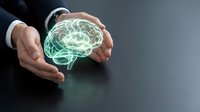 Businessman hands protecting glowing green brain hologram representing mental health care, artificial intelligence and cognitive protection in modern workspace.