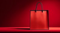 Red shopping bag on red background for retail marketing and promotional campaigns.