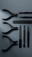 Black matte manicure and pedicure tools set arranged on dark gray background, including nippers, files, tweezers, and cuticle pushers.