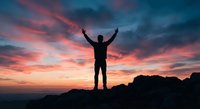 Silhouette of person with raised arms celebrating success on mountain peak against dramatic sunset sky with pink and blue clouds for motivation concepts.