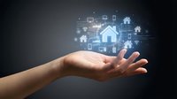 Smart home technology concept with digital icons floating above open palm showing connected devices and automation systems for modern living.