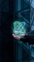 Businessman holding glowing holographic cube with geometric wireframe lines floating above palm in dark futuristic environment for technology concepts.