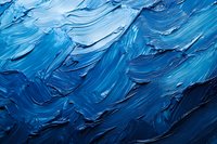 Abstract blue oil paint texture with thick brushstrokes and impasto technique creating dynamic waves and movement for artistic backgrounds and creative projects.