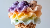 Colorful layered ice cream cone with purple, peach, yellow, and mint swirls topped with chocolate sprinkles against white background.