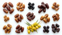 Assorted nuts and dried fruits including almonds, cashews, peanuts, dates, and raisins arranged on white background for food, nutrition, and healthy snacking content.