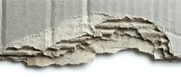 Torn and weathered paper edge with layered texture and shadow detail, suitable for design overlays, backgrounds, and creative projects.