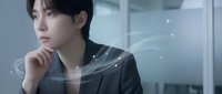 Young Asian businesswoman in dark suit touching chin thoughtfully with digital network connections and glowing particles around her in modern office environment.
