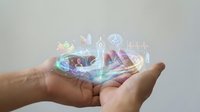 Cupped hands holding holographic digital icons representing modern technology, communication, and connectivity in futuristic interface design.