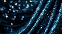 Shimmering blue fabric with glitter effect and bokeh lights creates magical festive backdrop for luxury events and holiday celebrations.