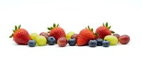 Fresh mixed berries and grapes arranged in colorful row on white background, isolated healthy organic fruit selection for nutrition and wellness concepts.