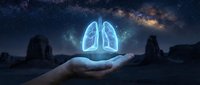Glowing lungs hologram floating above open palm against starry night sky background. Medical healthcare concept for respiratory system awareness and lung health protection.