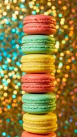 Colorful French macarons stacked in tower formation against festive bokeh lights background for bakery menu, dessert photography and holiday celebrations.