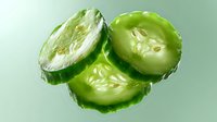 Fresh sliced cucumber with water drops and seeds on green background, macro photography showing juicy texture and natural vegetable detail.