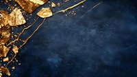 Gold leaf fragments and abstract paint splashes on dark navy blue textured background with copy space, luxury artistic design elements for creative projects.