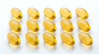 Golden omega-3 fish oil capsules arranged in rows on white background for health and wellness supplement marketing materials.