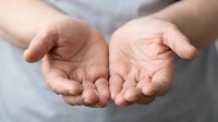 Open cupped hands gesture showing palms in receiving or giving position against neutral background for charity, support and help concepts.
