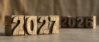 Wooden blocks displaying 2022 transitioning to 2021 on rustic surface. Year change concept for business planning and time passage reflection.