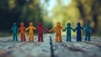 Colorful paper cutout figures holding hands in unity against blurred natural background, symbolizing diversity, community support and teamwork.
