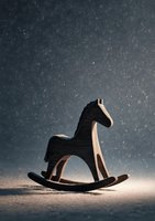 Wooden rocking horse toy silhouette against dark background with falling snow effect, evoking nostalgia and childhood memories.