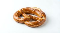 Freshly baked soft pretzel with golden-brown twisted knot shape, isolated on white background for bakery, food packaging, and menu design use.