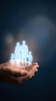 Glowing family silhouettes floating above protective cupped hands against dark blue background representing life insurance and family protection services.
