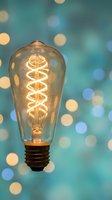 Vintage Edison bulb with spiral filament glowing warmly against soft bokeh lights background for creative lighting and interior design concepts.