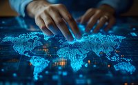 African American hands interacting with glowing blue digital world map interface on dark background, representing global technology and data connectivity.