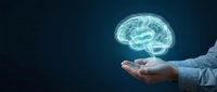 Businessman holding glowing digital brain hologram in cupped hands against dark blue background representing artificial intelligence and innovation.