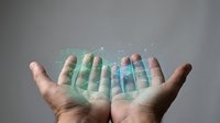 Open hands displaying holographic digital interface with glowing data visualization elements and futuristic technology overlay for business presentations.