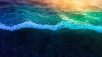 Ethereal abstract wave formation in vibrant blue and green tones with glowing particles and orange light effects creates mystical underwater atmosphere.