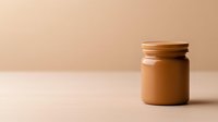 Minimalist composition featuring glass jar filled with creamy chocolate spread on beige background, creating modern aesthetic for food photography and packaging design.
