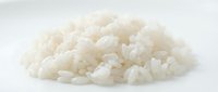 Pile of cooked white rice grains isolated on white background, ready for food and culinary design projects, cooking websites, recipe blogs, and restaurant menus.