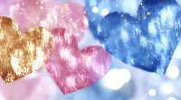 Romantic hearts in gold, pink and blue with bokeh effect on soft pastel background create wedding design atmosphere.