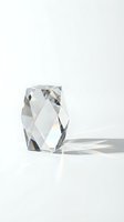 Clear crystal glass vase with geometric faceted design casting rainbow reflections on white surface for modern home decor and luxury interior styling.