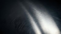 Dark brushed metal surface with dramatic light beams creating industrial metallic texture for modern design backgrounds and technology concepts.
