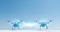 Pair of blue quadcopter drones with digital network connections against clear sky, representing technology, communication, and autonomous flight systems for commercial and industrial applications.