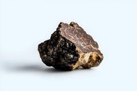 Raw mineral stone specimen with rough dark surface and crystalline structure on white background, showcasing natural geological formation and texture.