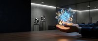 Young male hand holding glowing blue crystal hologram in modern gallery space with sculptures and ambient lighting for technology and innovation concepts.