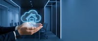 Businessman holding glowing cloud home icon in server room, representing smart home technology, cloud computing, and digital infrastructure solutions for modern connected living.