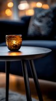 Glowing amber glass candle holder on wooden table with soft bokeh lights creates cozy evening atmosphere. Gentle smoke rises adding mystical mood.