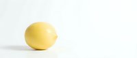 Single fresh yellow lemon fruit isolated on clean white background for culinary design and healthy cooking projects.
