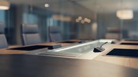 Tablet and stylus on wooden conference table in modern office meeting room with blurred background for business and technology concepts.