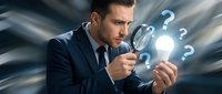 Young businessman in suit examining glowing question marks with magnifying glass representing problem solving and decision making in corporate environment.