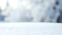 Empty white surface with soft blurred winter background for product display and presentation purposes in commercial photography projects.