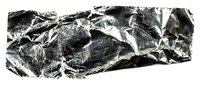 Crumpled metallic foil with reflective silver surface and deep shadows, suitable for backgrounds, textures, and design overlays.