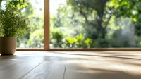 Sunlit wooden floor with potted plant by window, natural light casting soft shadows across empty space, creating serene minimalist home interior atmosphere.